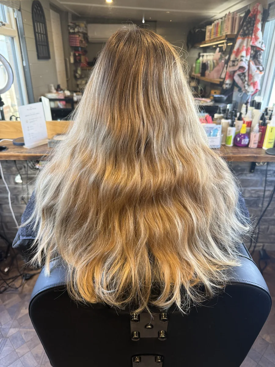 Before: warm blonde ombré changed to a rich, glossy chocolate brunette with soft waves