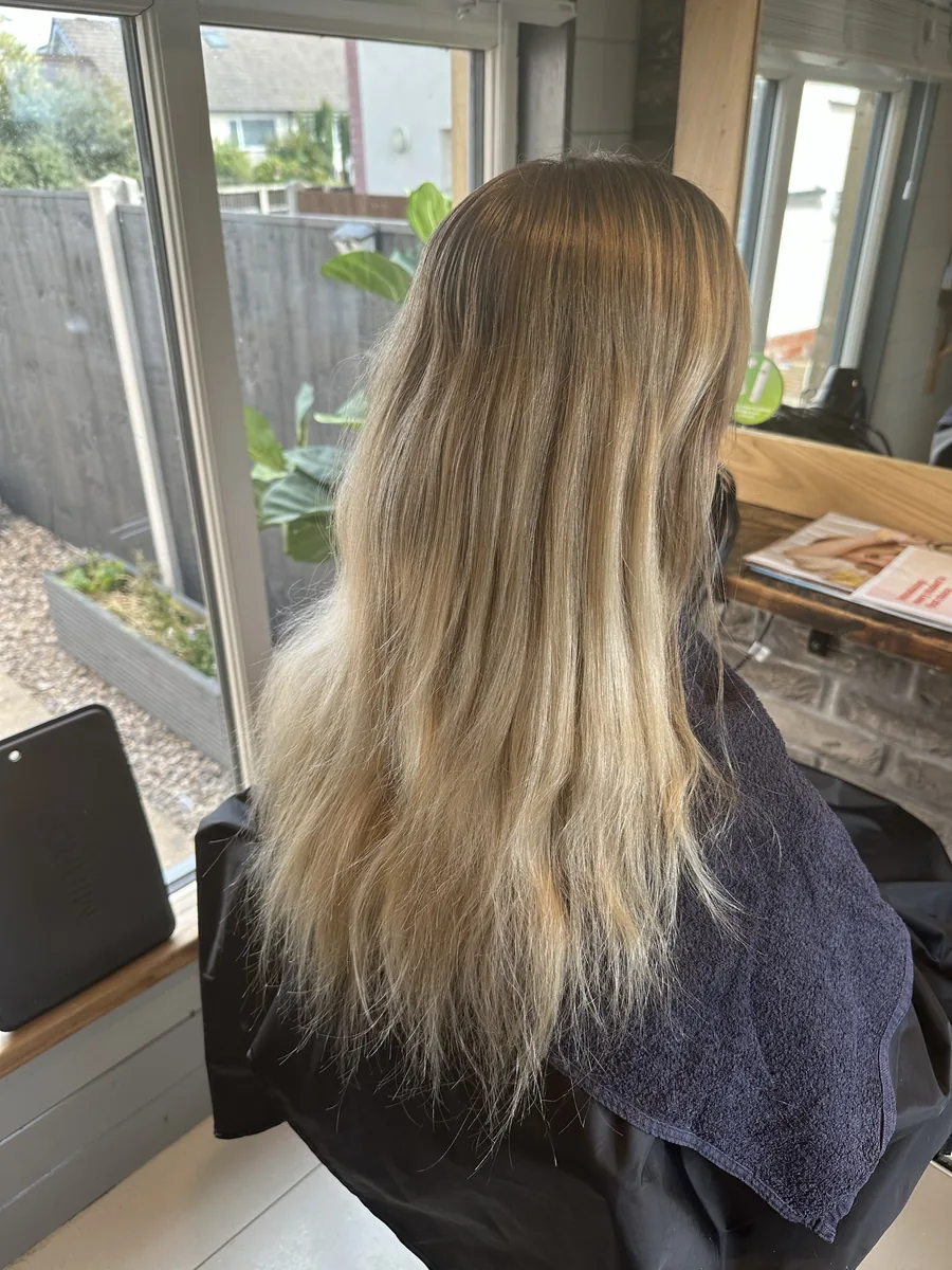 Before: yellow-toned blonde refreshed to a soft beige blonde with long layers