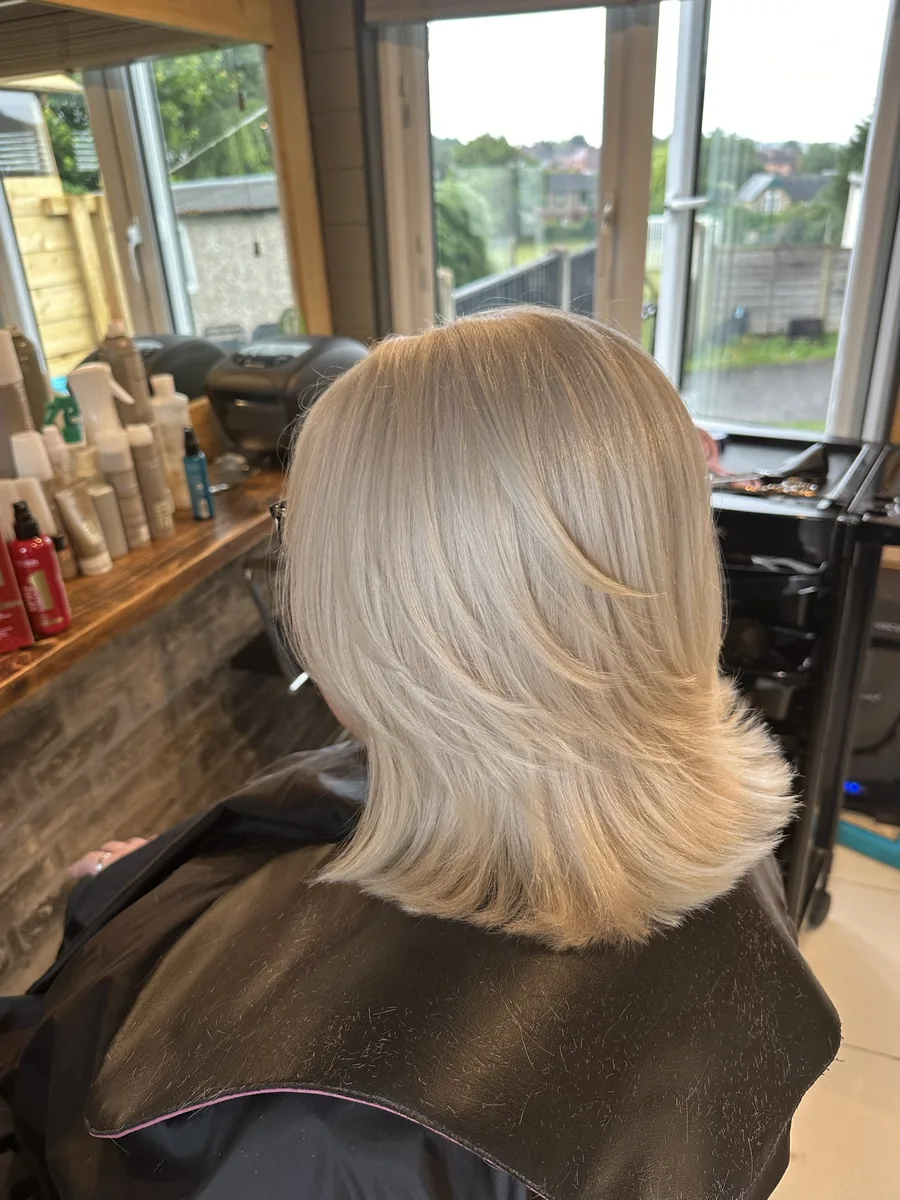 Bright platinum blonde in a layered, flicked bob