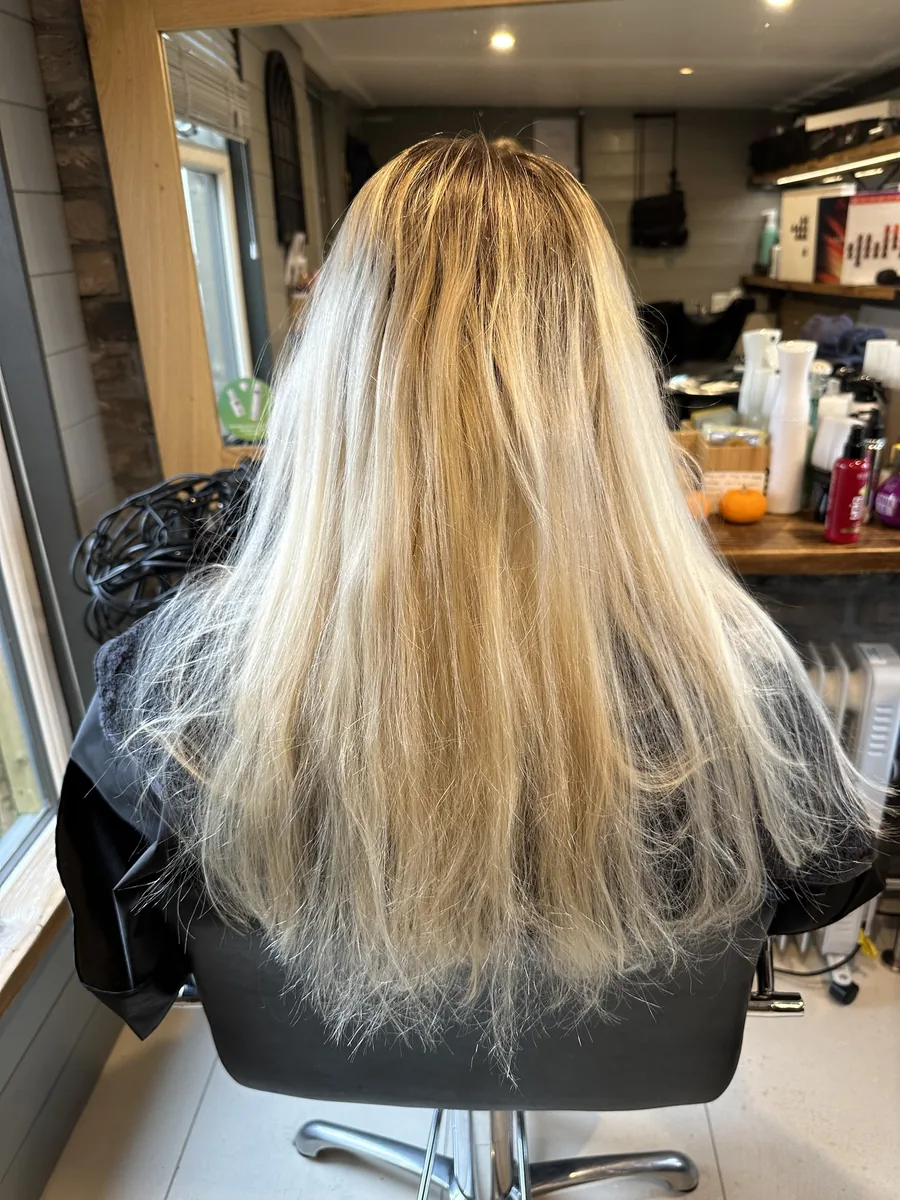 Before: long, dry platinum blonde with dark roots changed to warm honey blonde waves