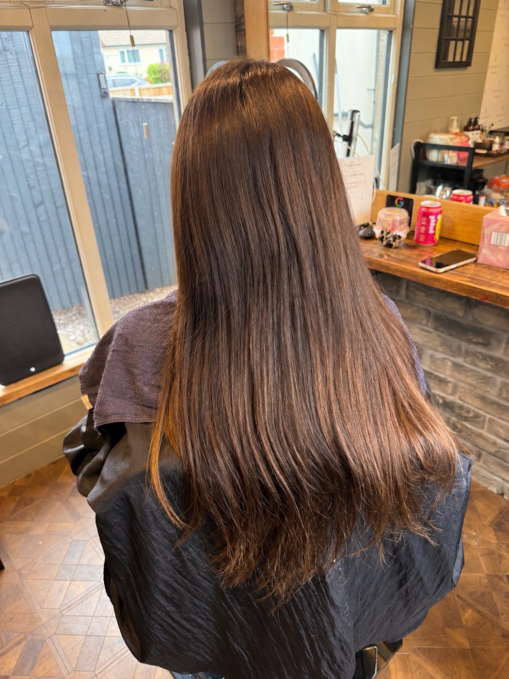Before: long brunette hair refreshed to a rich, glossy brunette with a bouncy blow-dry