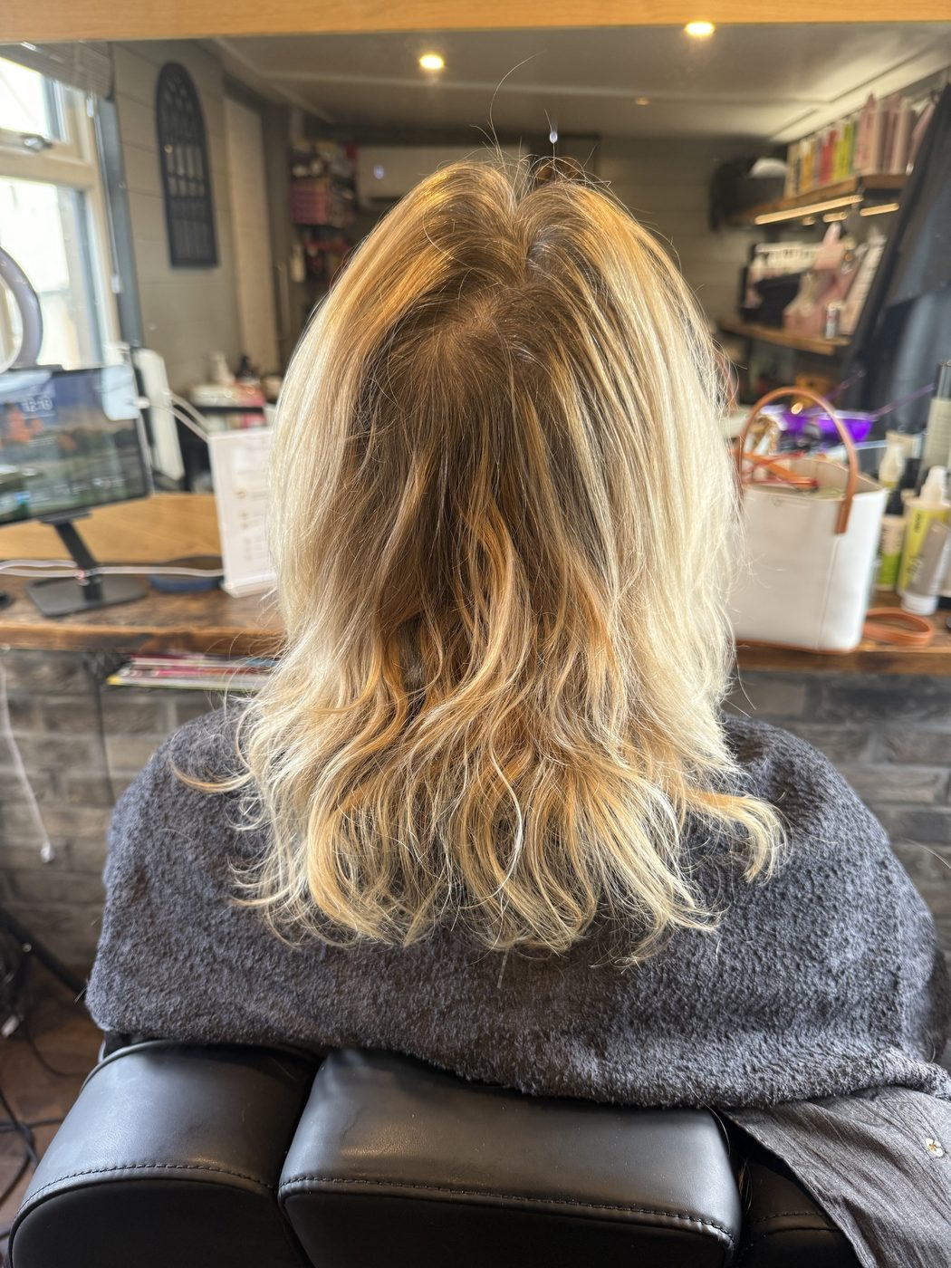Before: dry, grown-out blonde lifted and cut into soft, bouncy layers