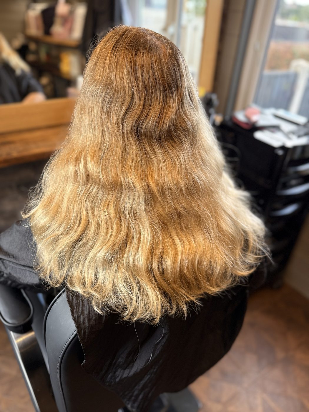 Before: brassy lengths toned to a bright, creamy blonde with a smooth blow-dry