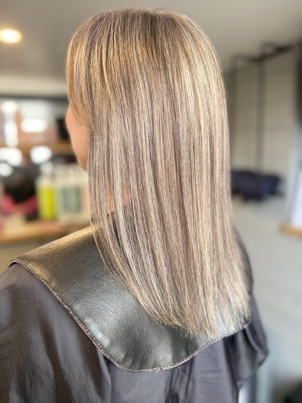 After: orange-toned hair corrected to a cool, blended blonde